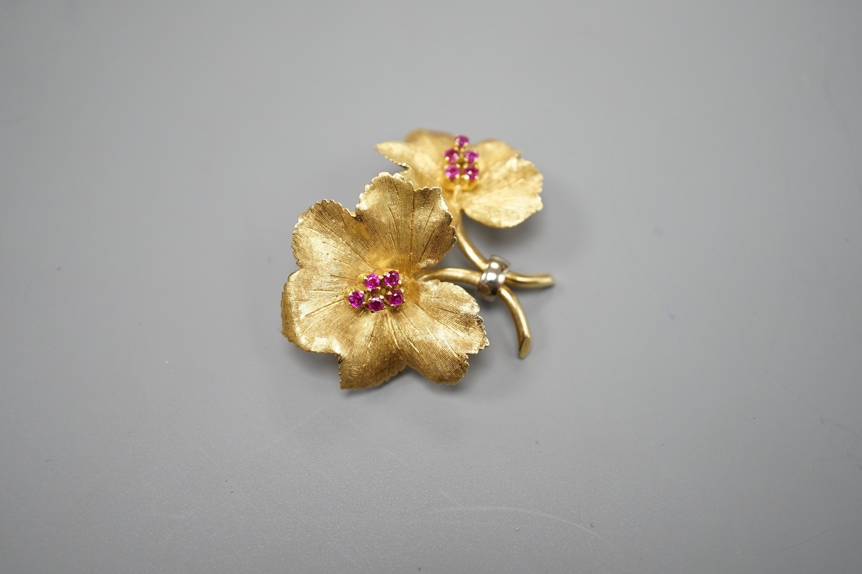 A gold and ruby cluster set double flower head brooch